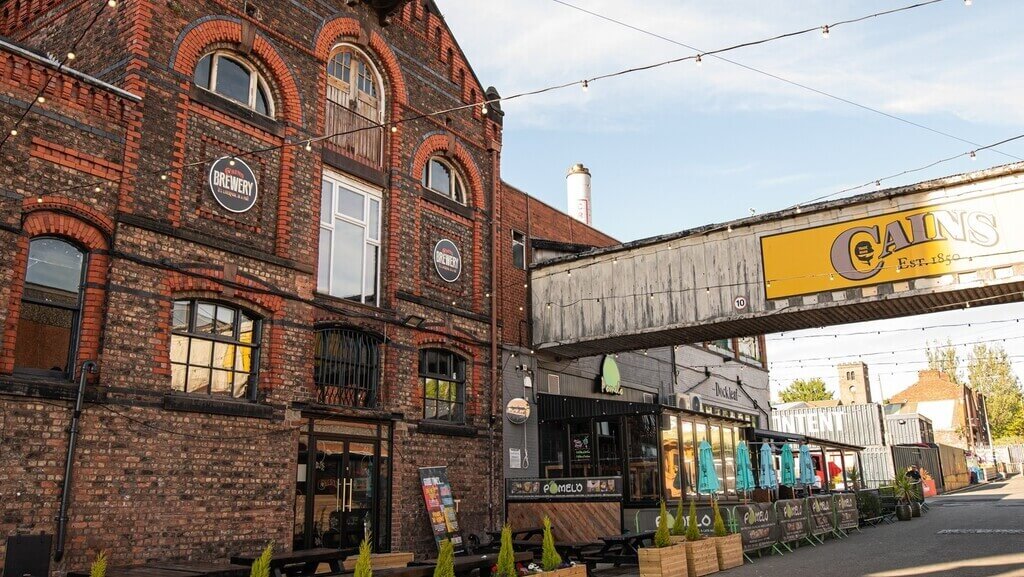 The exterior of Cain's Brewery Village in Liverpool, a unique heritage site transformed into a bustling social venue for fun activities