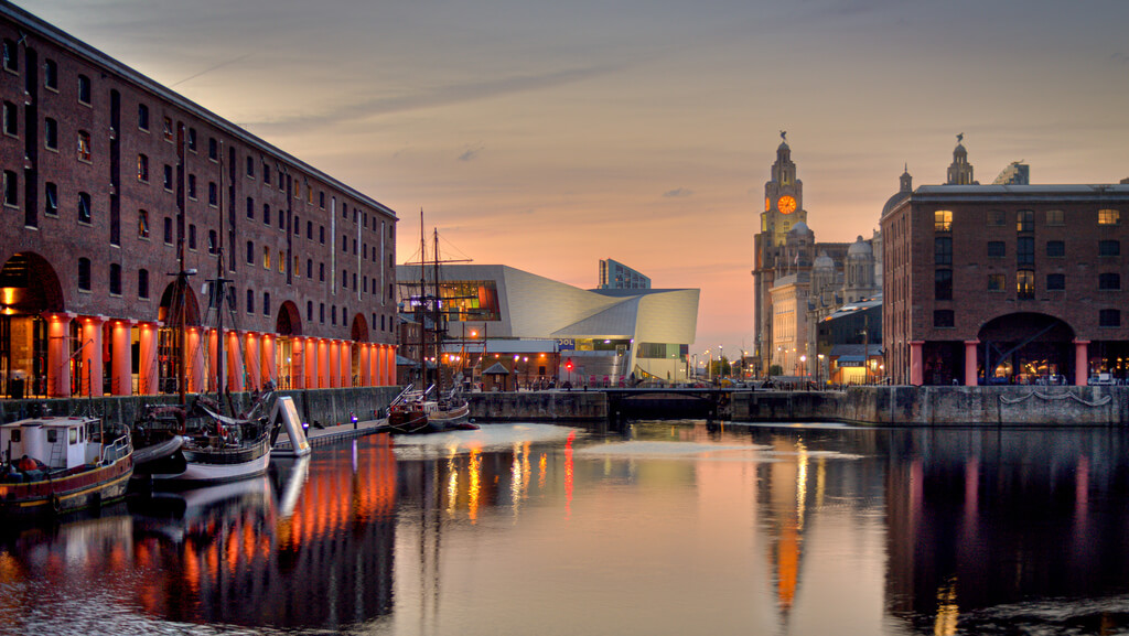 A serene sunset view over the historic docks of Liverpool, reflecting the city's unique charm and inviting fun exploration