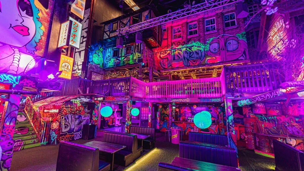 Inside Golf Fang, a vibrant and unique venue in Liverpool for fun and entertainment with a graffiti-themed decor