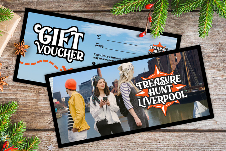 A gift voucher for Treasure Hunt Liverpool on a table covered with Christmas decorations