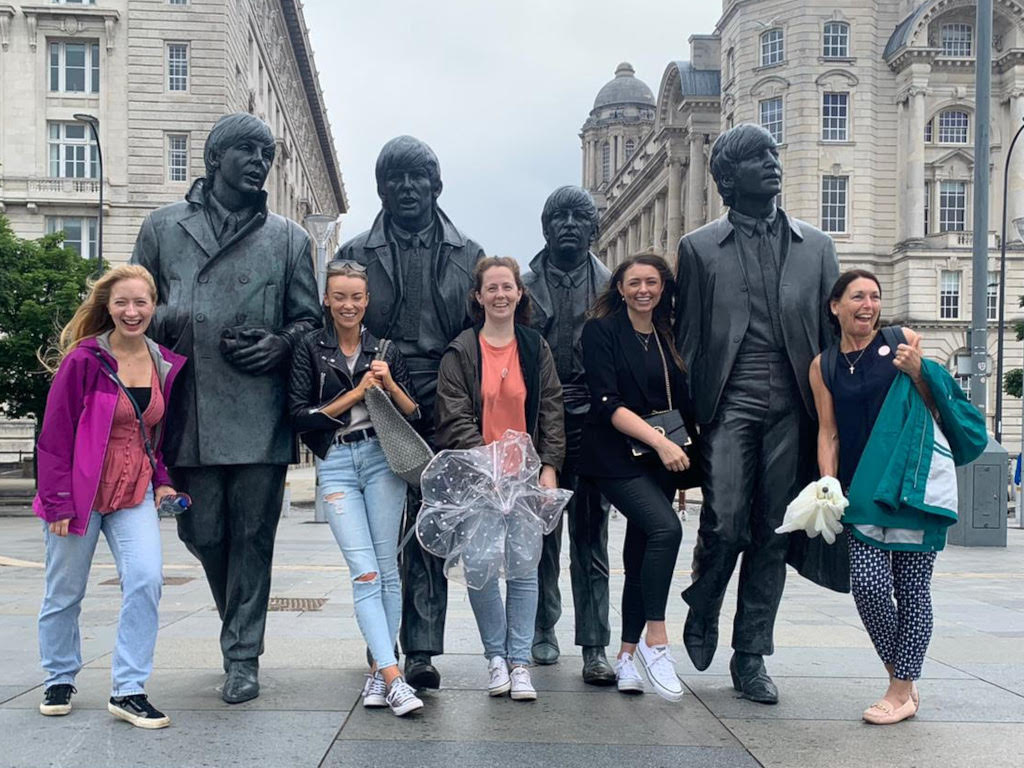 A hen party in front of the Beatles Statues during Treasure Hunt Liverpool